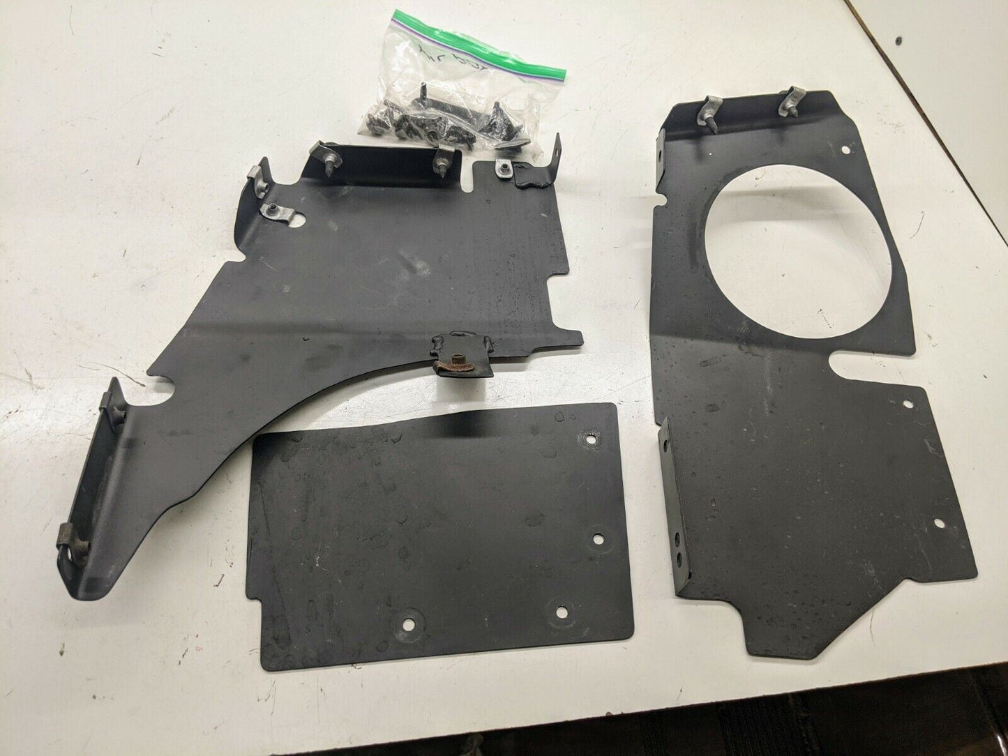 The Ugly Truckling’s 1995–2005 Chevy S10 Blazer LS Swap Cold Air Box, custom fabricated for a factory look, is shown with screws and fasteners on a white surface, displayed side by side.