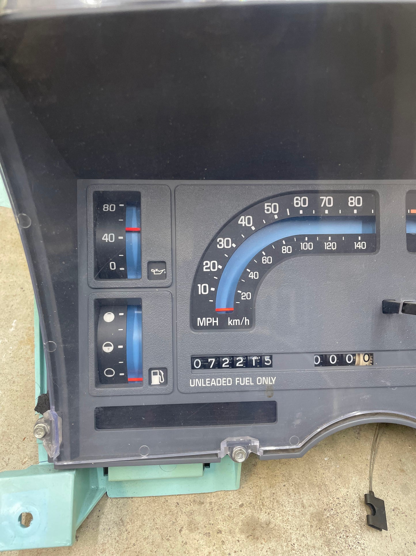 Close-up of a General Motors OEM Instrument Cluster for 1986–1989 Chevy S10 Blazer, showing a mechanical speedometer (MPH/km/h), tachometer, PRNDL, oil pressure & temp gauges. Odometer reads 72K miles; UNLEADED FUEL ONLY label below.