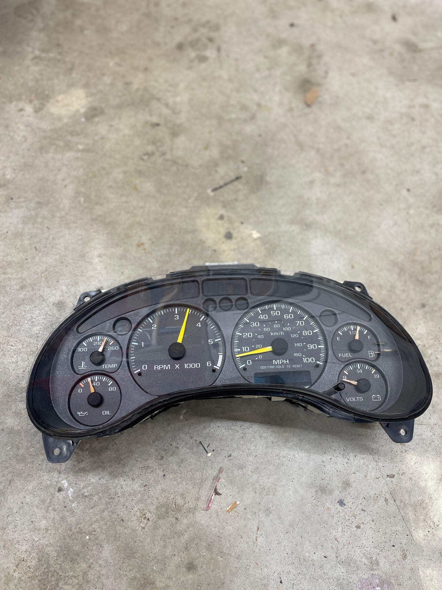A General Motors OEM tested instrument cluster with tachometer fits 2001-2005 Chevy S10 or Blazer with console shifter, displaying oil, temp, RPM, speedometer, volts, and fuel gauges; ideal for manual transmission models.