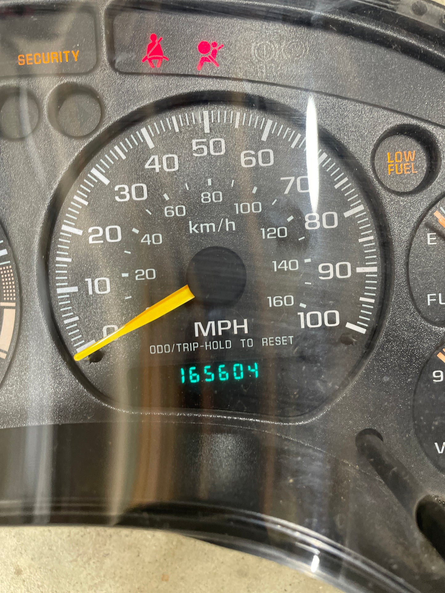 A General Motors OEM Tested Instrument Cluster with Tachometer for 2001-2005 Chevy S10/Blazer (console shifter) displays 0 MPH, 165604 miles, active security, seatbelt, LOW FUEL lights; speedometer reads up to 120 MPH/200 km/h.