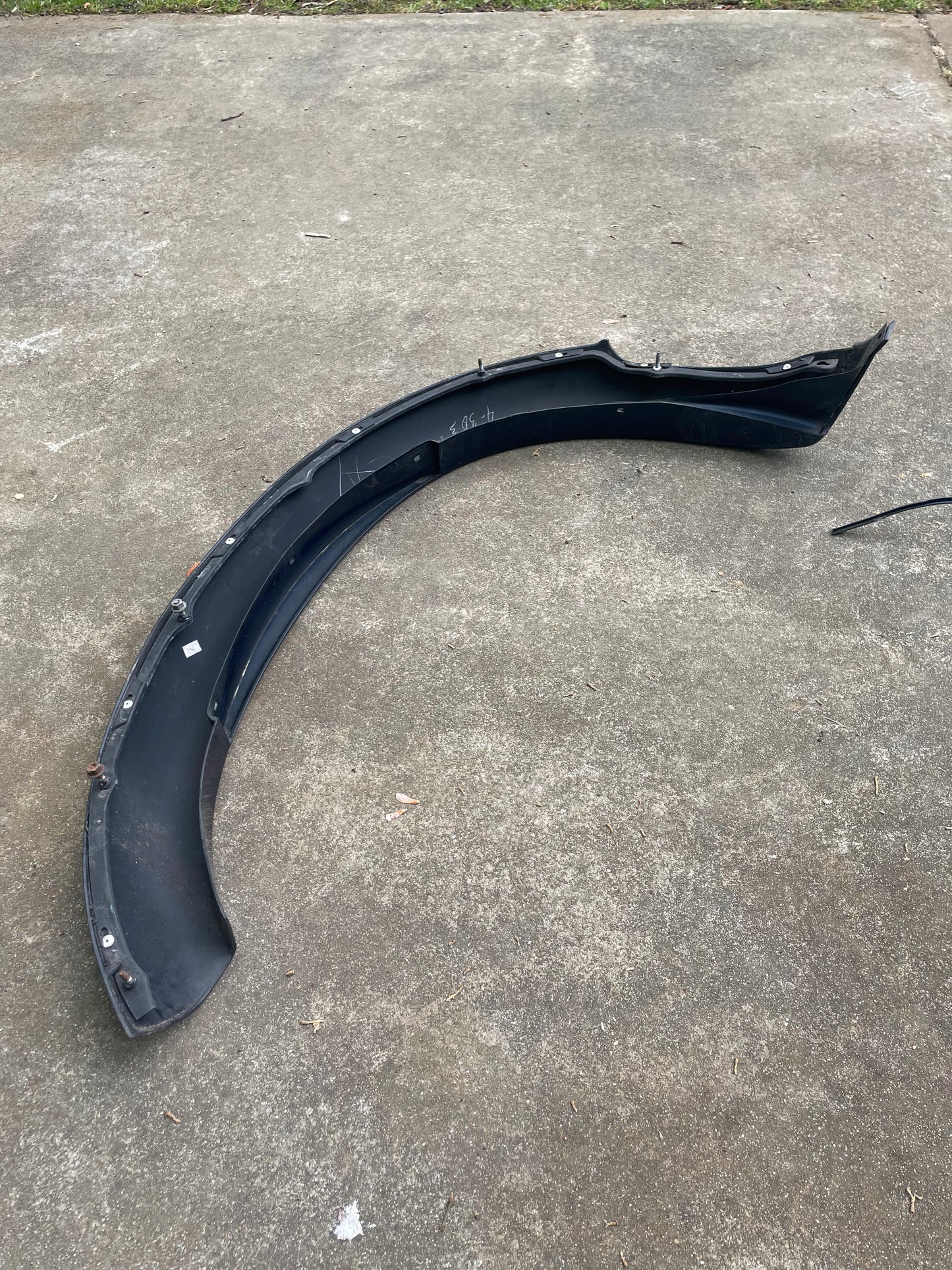 A blue General Motors OEM Front Right Passenger ZR2 Fender Flare Extension for 1994-2005 Chevy S10 and GMC Sonoma rests on the ground.