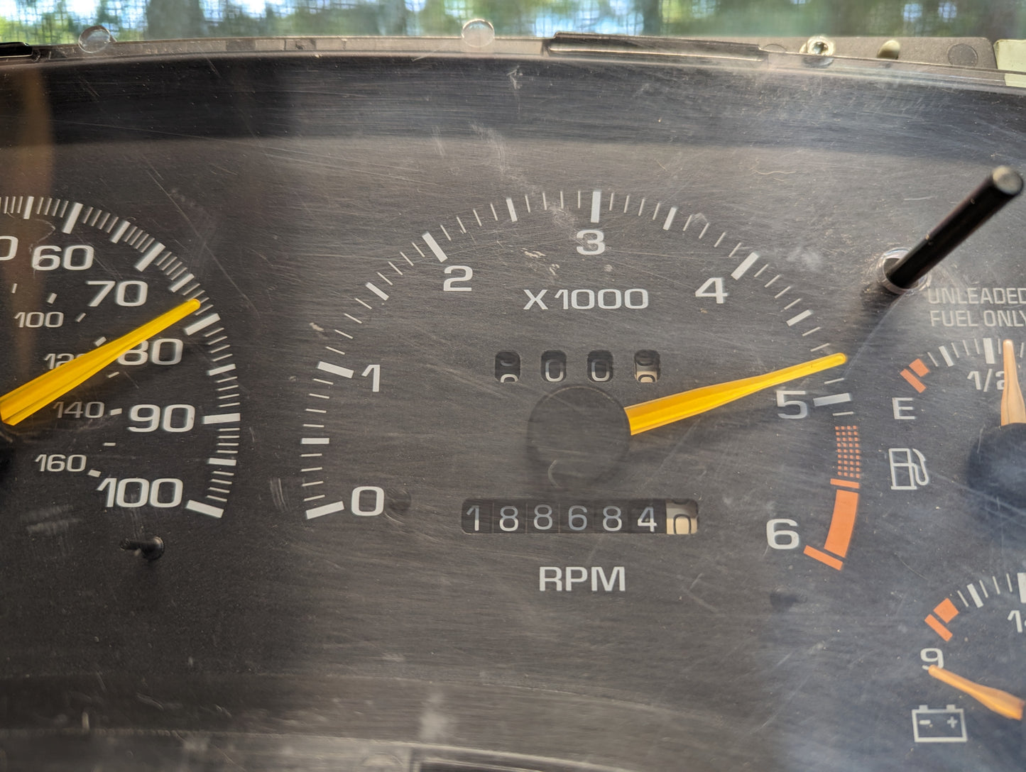 A General Motors OEM Instrument Cluster for 1995-1997 Chevy S10 or Blazer with Console Shifter shows a tachometer at 4900 RPM, odometer at 188684 miles, and the right fuel gauge indicates low fuel.