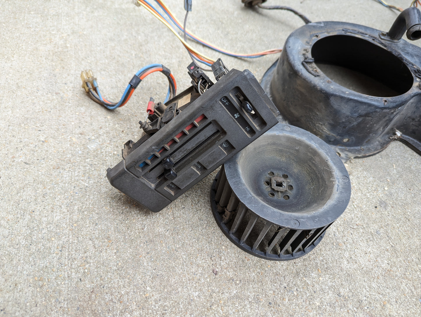 The General Motors OEM A/C Delete Heater Box & Control Panel Swap Parts for 1986-1994 S10, Blazer, and more includes a heavy duty heater box, HVAC control panel (sliders/buttons), wiring, and blower fan—ideal for A/C delete upgrades.