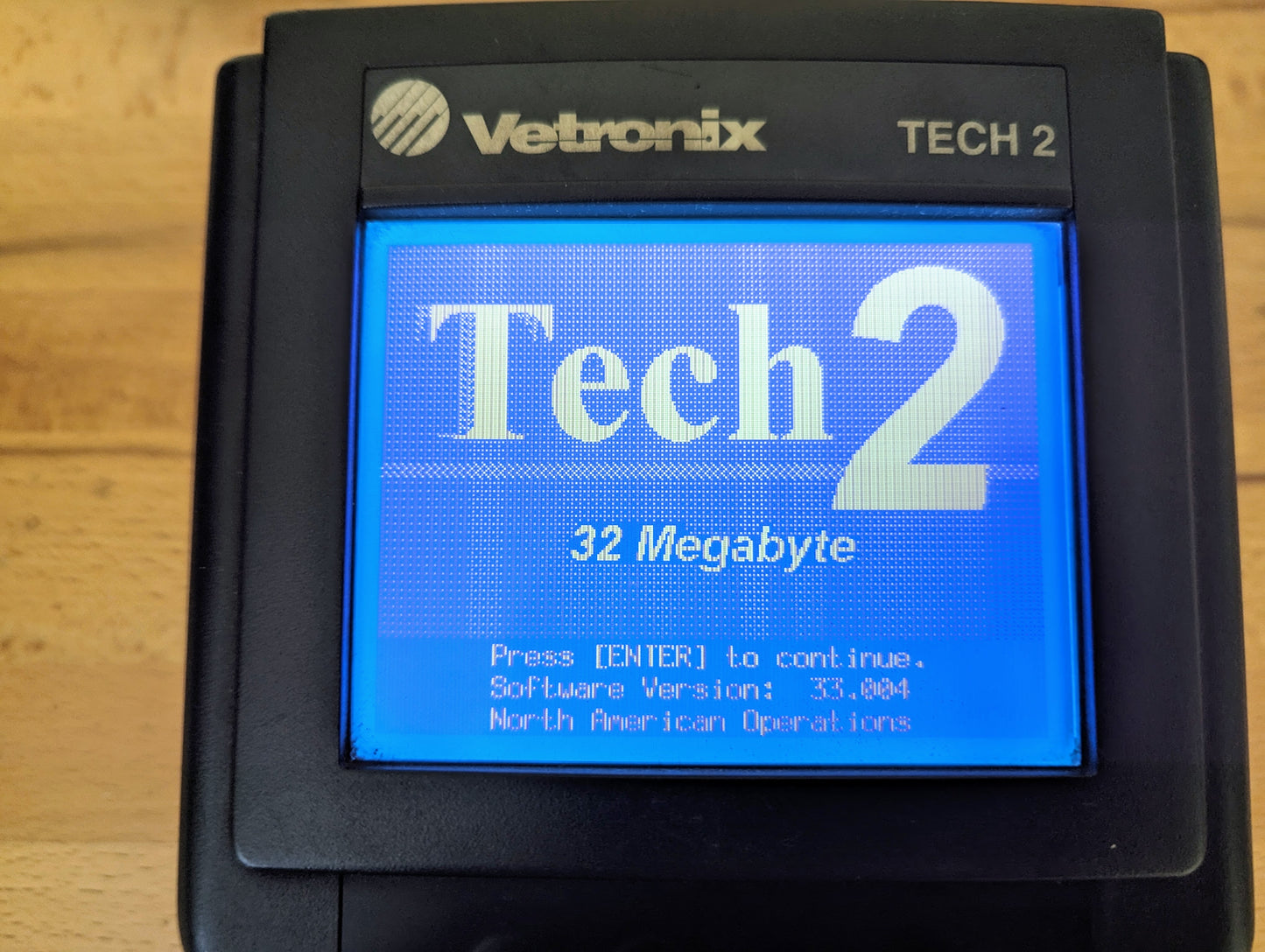 A close-up of a Vetronix TESTED Tech 2 Automotive Diagnostic Tool & Accessories for 1991–2013 GM Vehicles screen displays its reliable OBD2 scanning features and software version information.