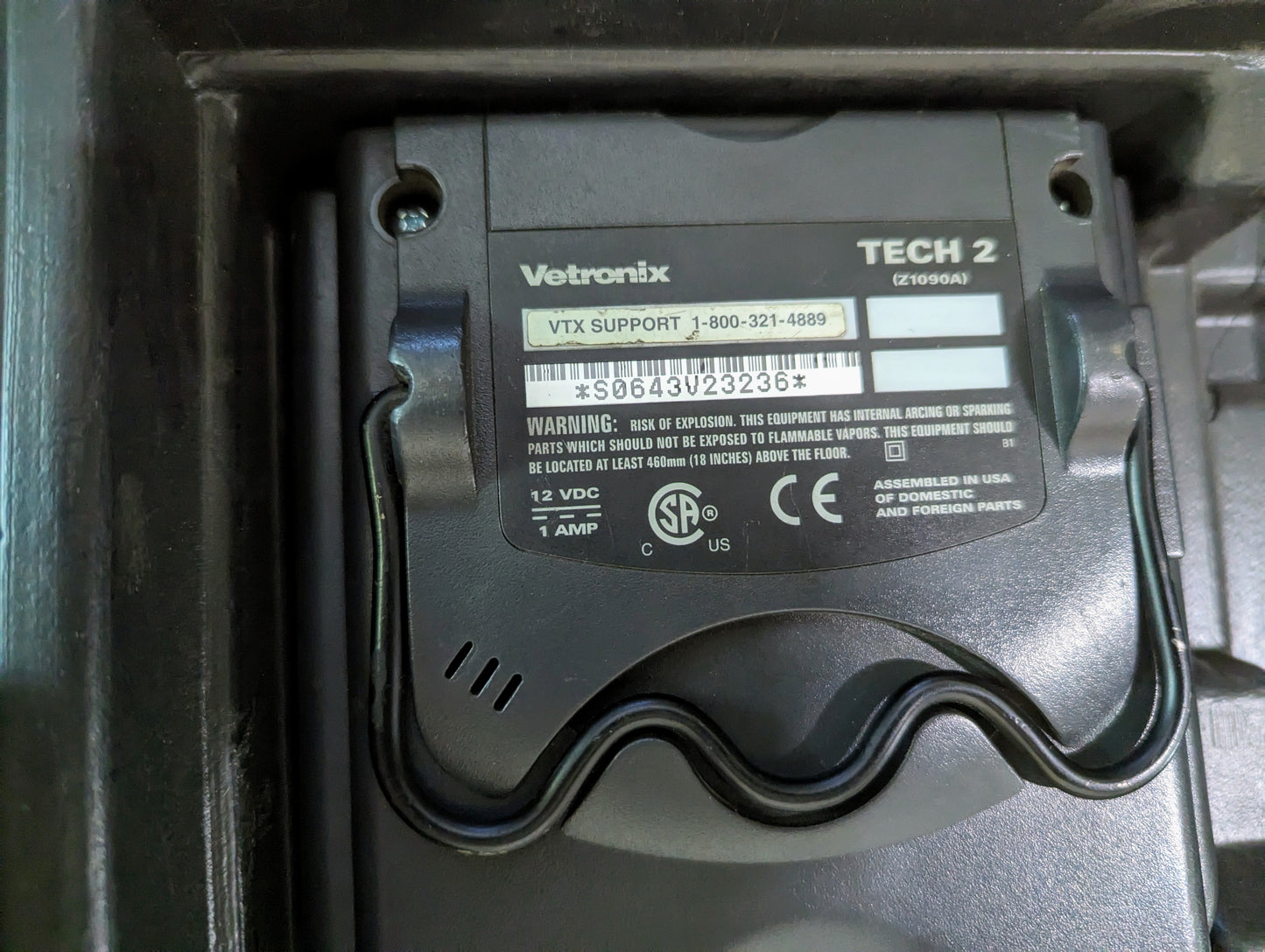 Close-up of the back label on a Vetronix TESTED Tech 2 Automotive Diagnostic Tool & Accessories for 1991-2013 GM Vehicles, showing model, serial number, support phone number, and certification/warning info.