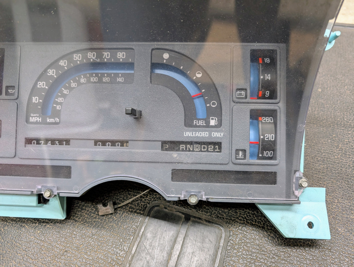 A close-up of a General Motors Low Mile 74K OEM Instrument Cluster with PRNDL for 1986-1994 Chevy S10 Blazer shows analog gauges, an 85 MPH speedometer, nearly empty fuel, and gear indicator for P R N D 0 2 1.