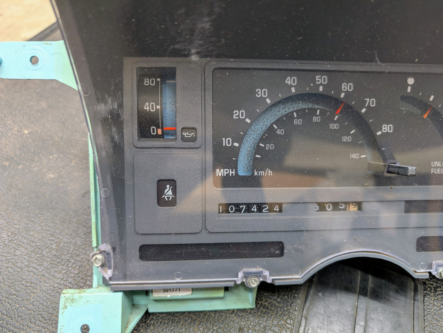 A close-up shows a General Motors Low Mile 107K OEM Instrument Cluster for 1986-1994 Chevy S10 Blazer, featuring analog speedometer, odometer, fuel and temperature gauges typical of these models.