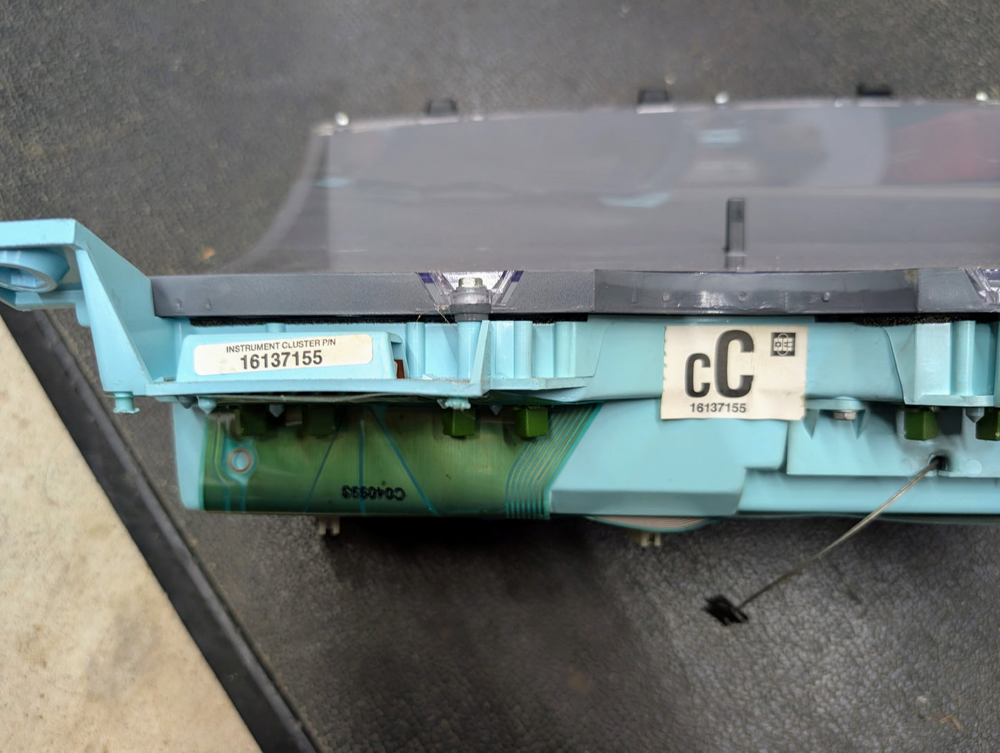 A close-up of a General Motors OEM Instrument Cluster with PRNDL and 110 mph Speedo (for 1986-1994 Chevy S10 Blazer, Part Number 16137155) sits beside a QR code on a dark textured background.