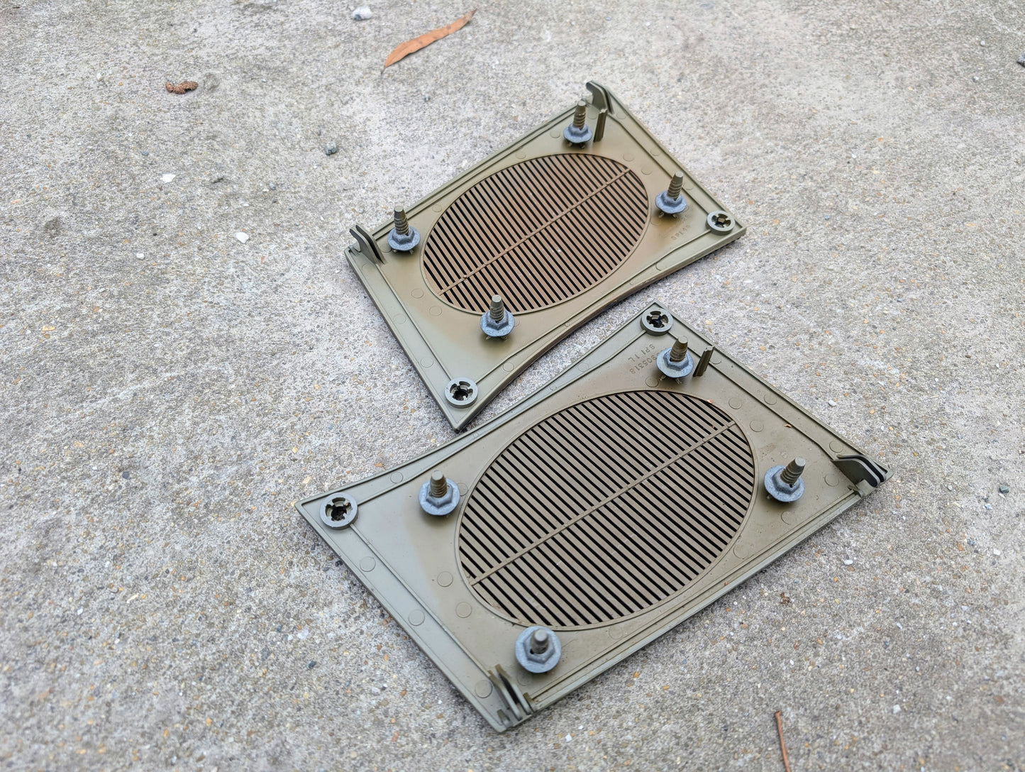 Two plastic grilles with nuts on a concrete surface