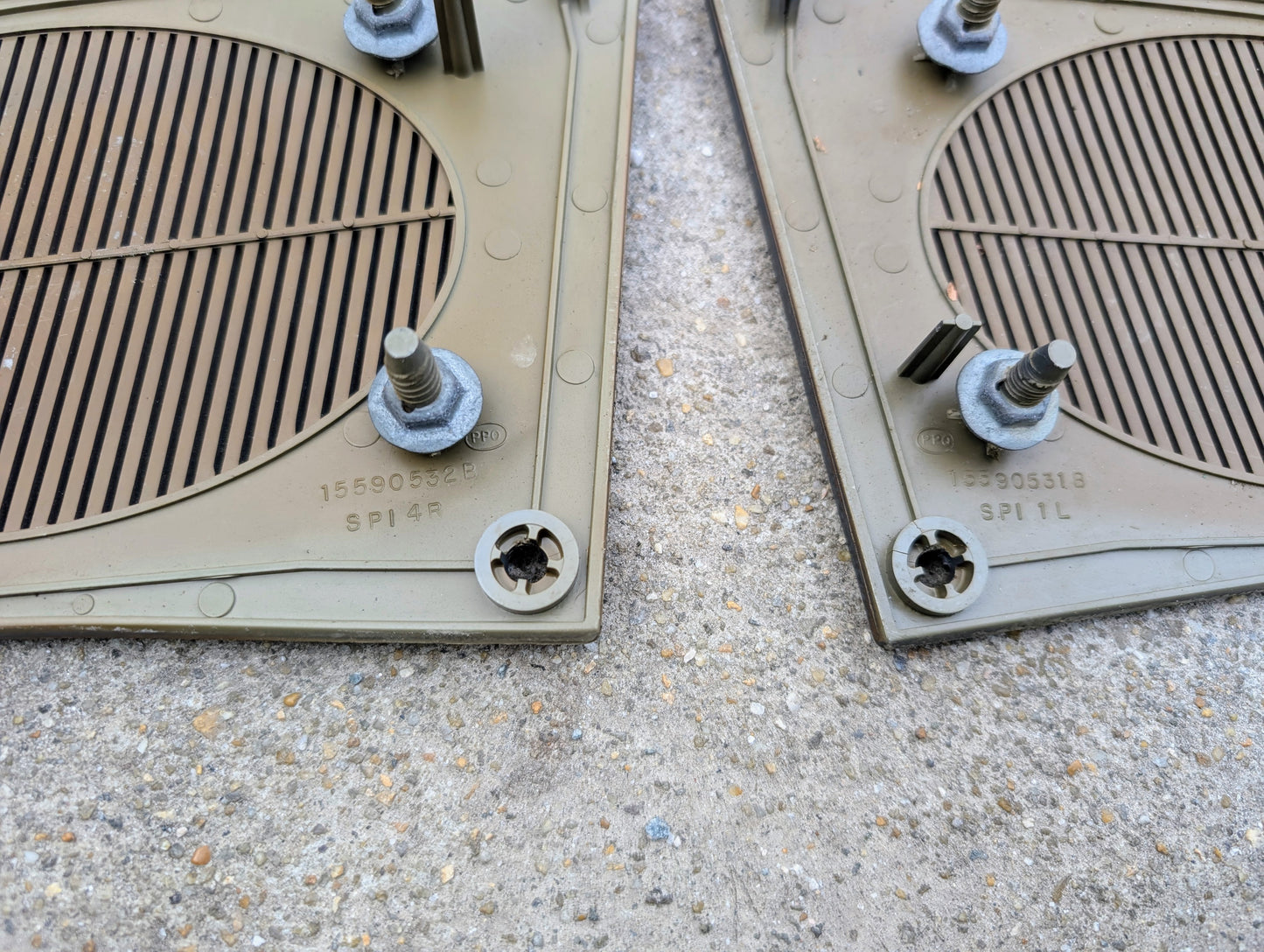 Two plastic grates with nuts on a concrete surface