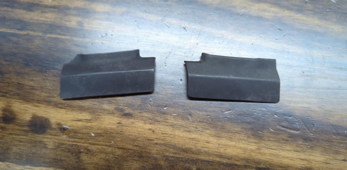 A pair of OEM General Motors rear window molding trim panel covers for 1991-1994 Chevy S10, Blazer, GMC S15 Jimmy, and more are shown side by side on a wooden surface.