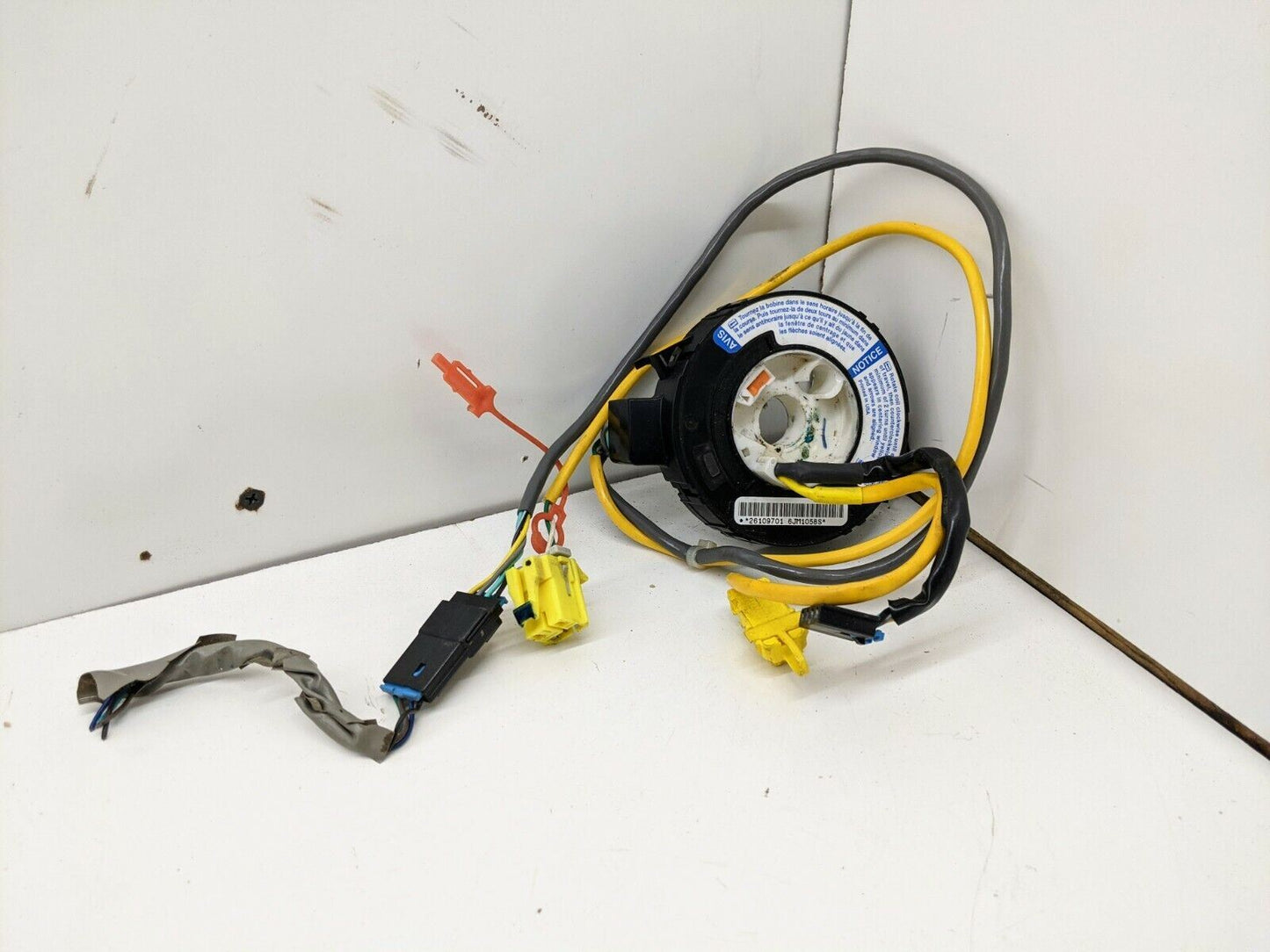 A General Motors OEM Steering Wheel SRS Air Bag Clock Spring, tested with radio controls for 2004-2005 Chevy S10 Blazer and more, rests on a white surface—perfect for restoring steering wheel functions.