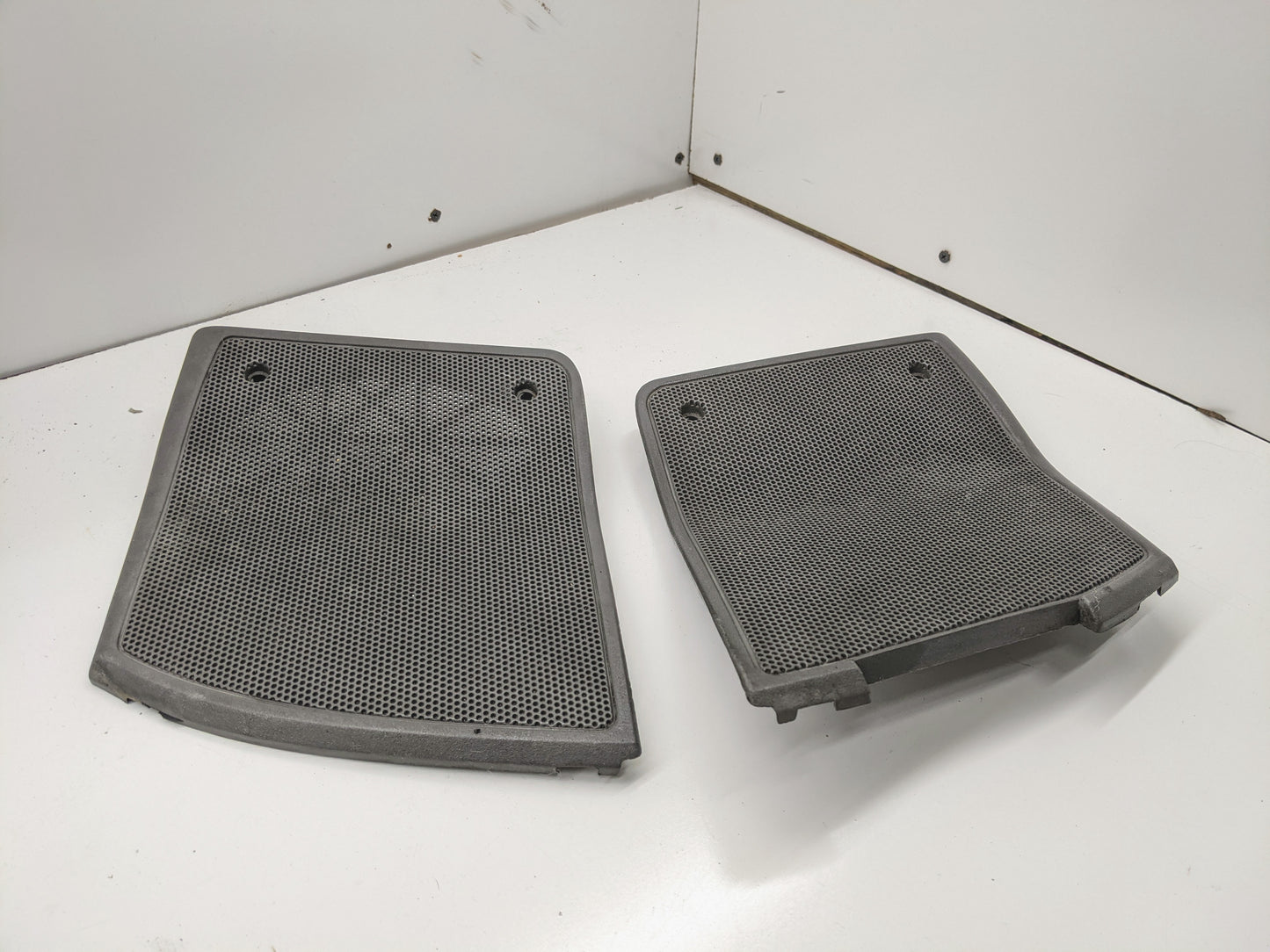 General Motors OEM light gray LH and RH dash speaker grille covers for 1995-1997 Chevrolet S10, Blazer, and more feature a rectangular design with rounded edges and mounting holes—ideal for updating your interior.