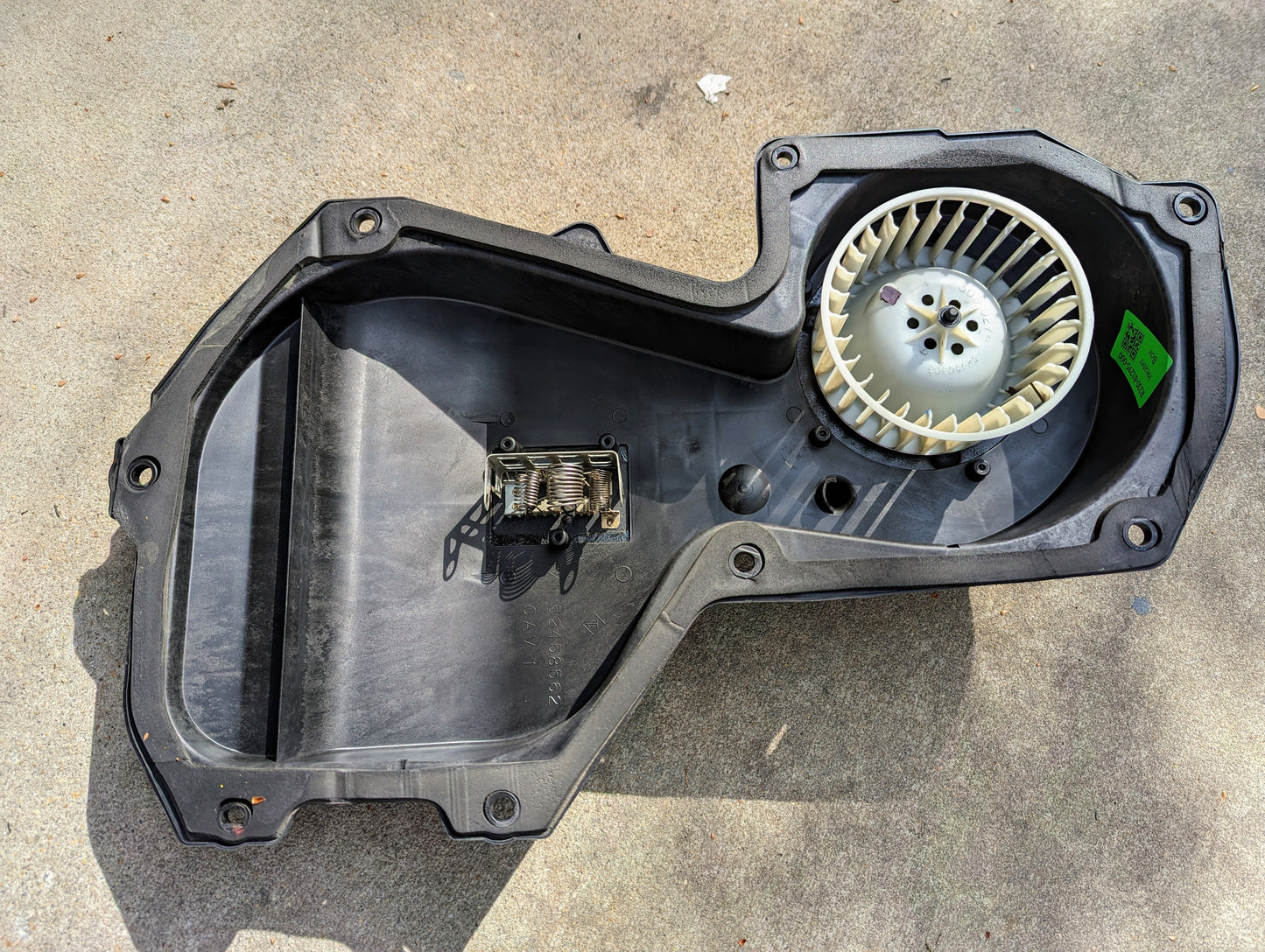 The General Motors OEM HD Heater A/C Delete with Control Panel for 1998-2005 Chevy S10, Blazer, and more features a built-in fan and inner-mounted resistor, shown on concrete in sunlight.