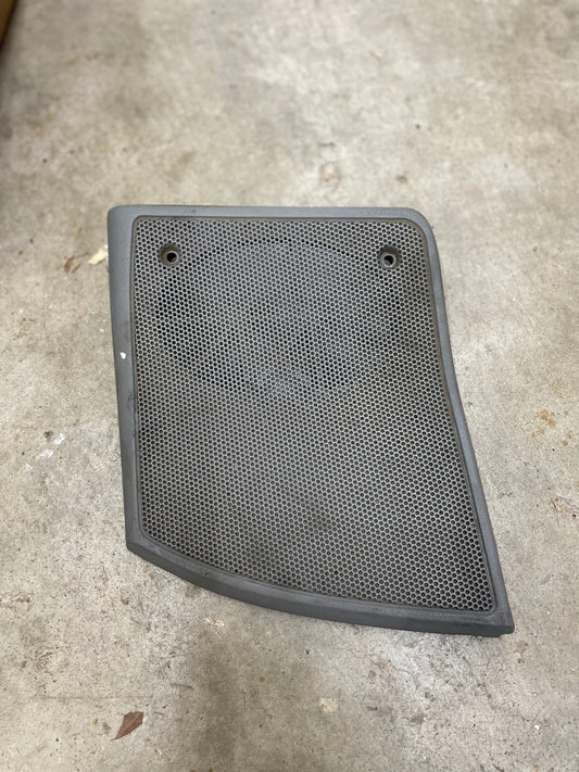 A light gray OEM Passenger RH dash speaker grille cover by General Motors with a broken tab, designed for 1995-1997 Chevrolet S10, Blazer, and more models, ideal for speaker maintenance.