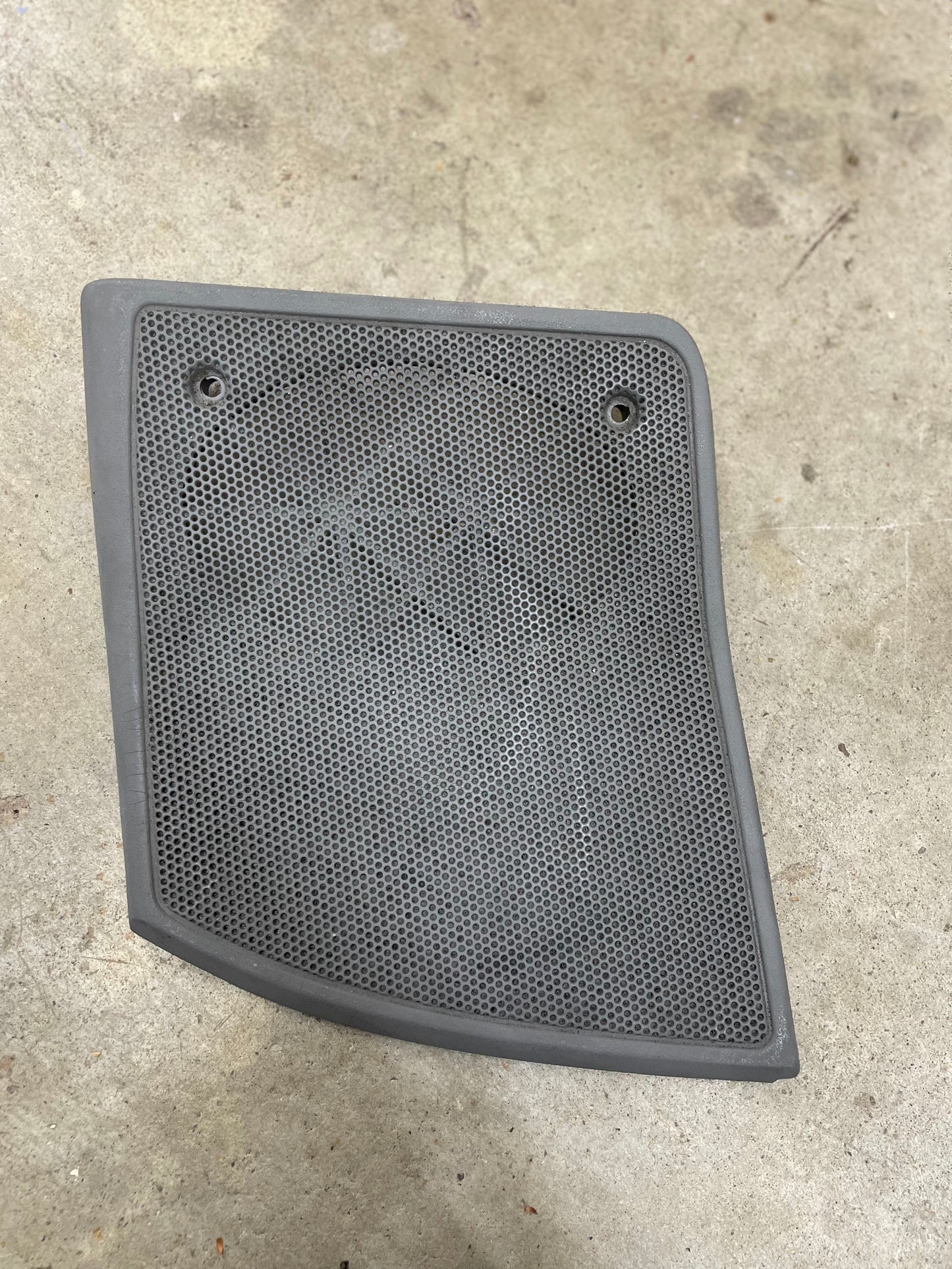 A light gray OEM passenger RH dash speaker grille cover by General Motors, with a broken tab, designed for 1995-1997 Chevrolet S10, Blazer, and more models.