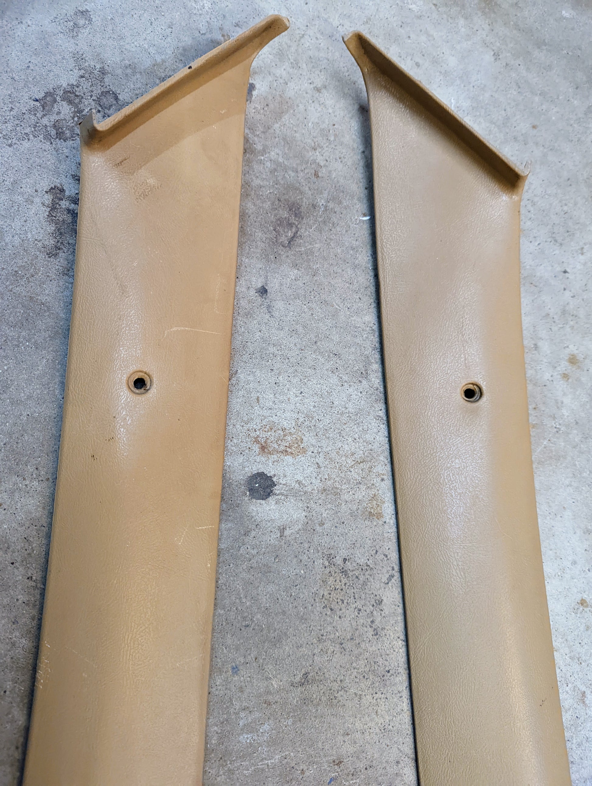 Pair of OEM General Motors A Pillar Trim Panels, tan 64I, for 1982-1993 Chevrolet S10, Blazer & more; textured plastic with center hole—perfect for restoring your interior.