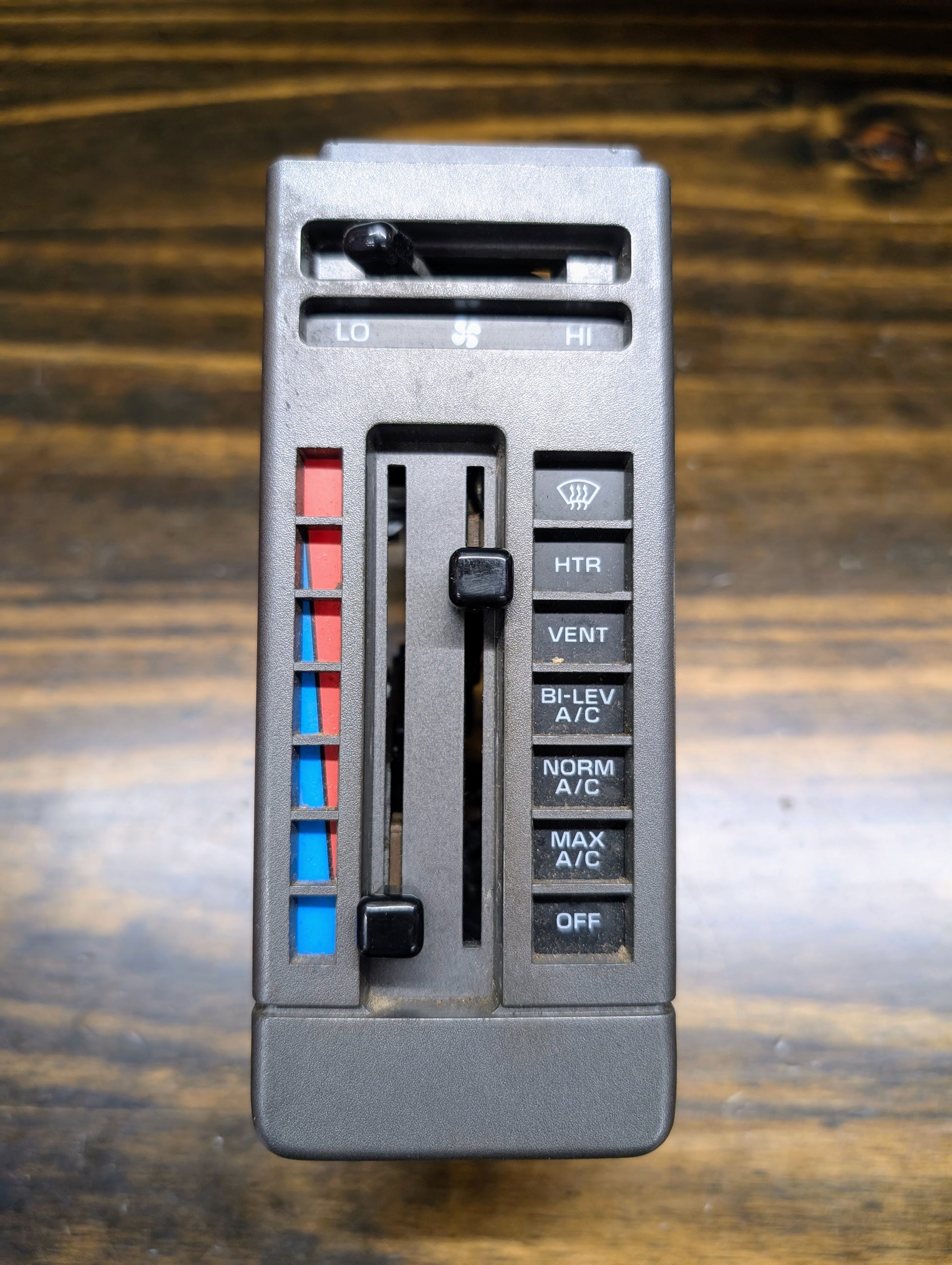 Close-up of the General Motors HVAC Heater Control Panel with A/C for 1986–1994 Chevrolet S10, Blazer, and more; features sliders and buttons for temperature, fan speed, airflow, and blue-to-red temperature scale.