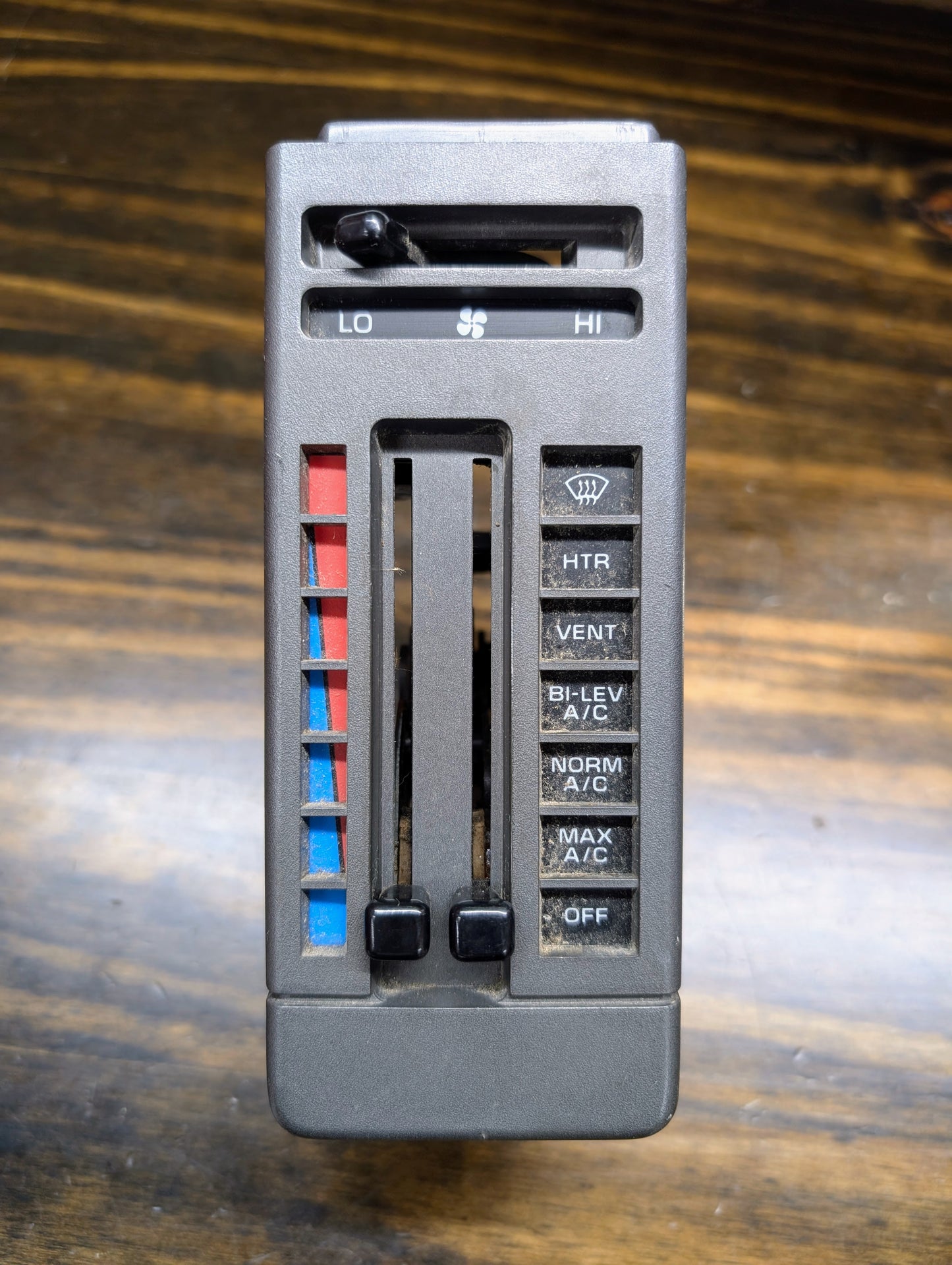 A General Motors HVAC Heater Control Panel with A/C for 1986-1994 Chevrolet S10 and Blazer features sliding levers for temperature and fan speed, plus buttons: HT, VENT, BI-LEV, NORM A/C, MAX A/C, and OFF.