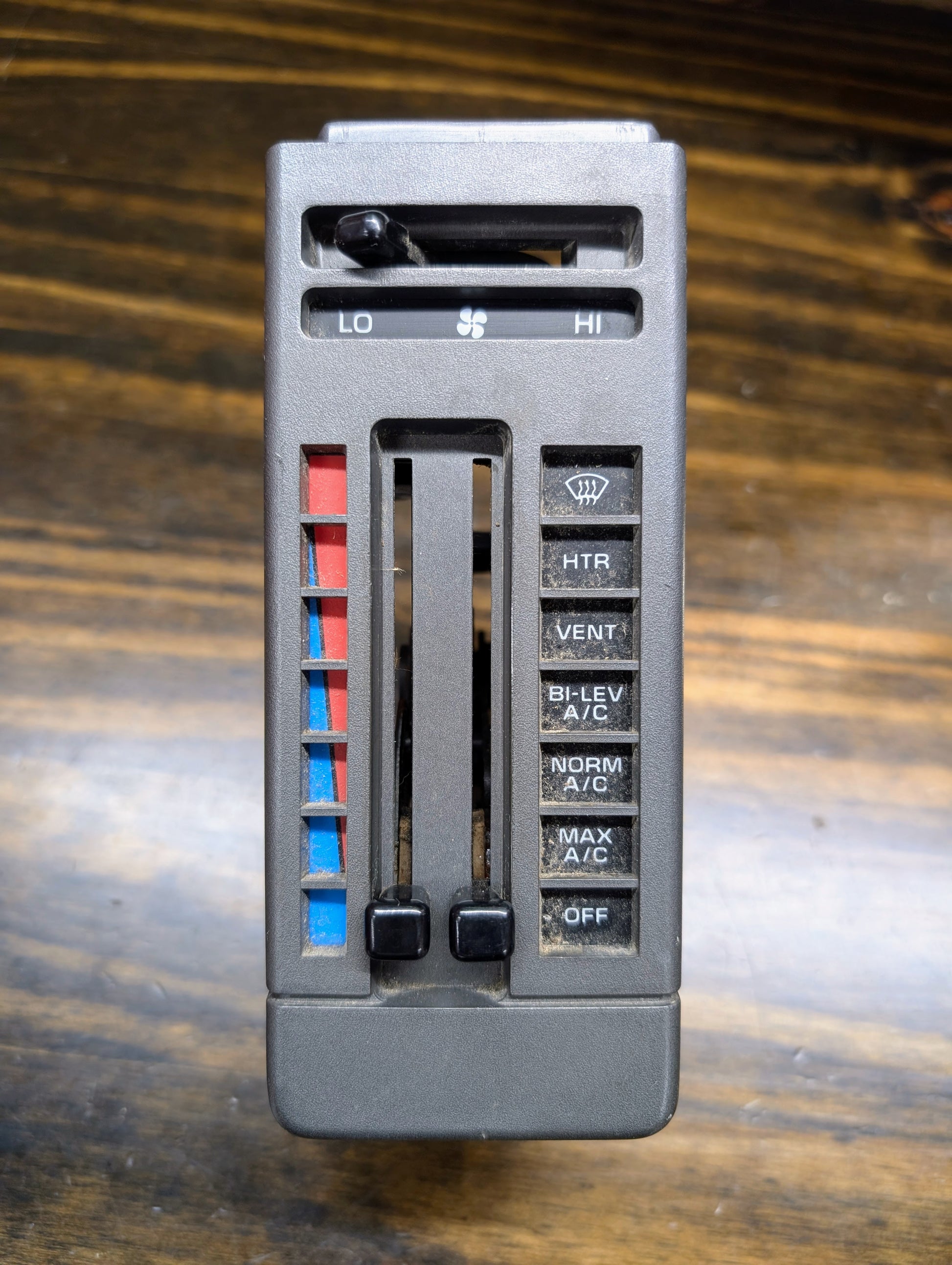 A General Motors HVAC Heater Control Panel with A/C for 1986-1994 Chevrolet S10 and Blazer features sliding levers for temperature and fan speed, plus buttons: HT, VENT, BI-LEV, NORM A/C, MAX A/C, and OFF.