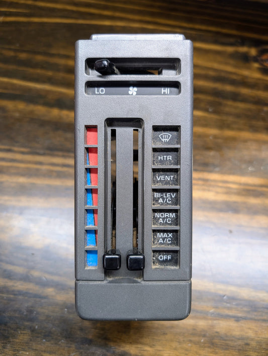 A General Motors HVAC Heater Control Panel with A/C for 1986-1994 Chevrolet S10 and Blazer features sliding levers for temperature and fan speed, plus buttons: HT, VENT, BI-LEV, NORM A/C, MAX A/C, and OFF.