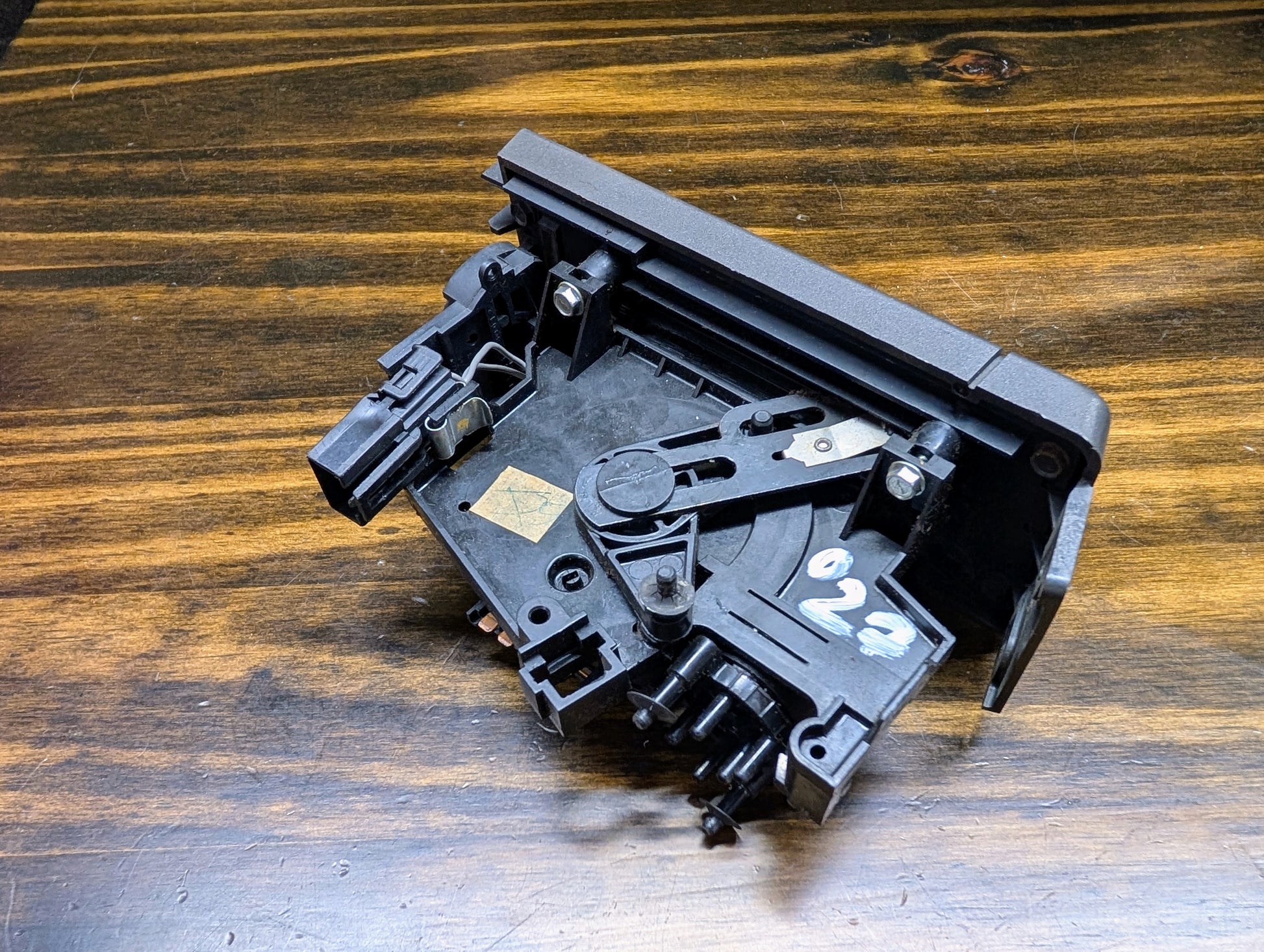 A black, rectangular General Motors HVAC Heater Control Panel with A/C for 1986-1994 Chevrolet S10, Blazer, and more sits on a wood-grain surface. White handwritten 022 is marked on one side.