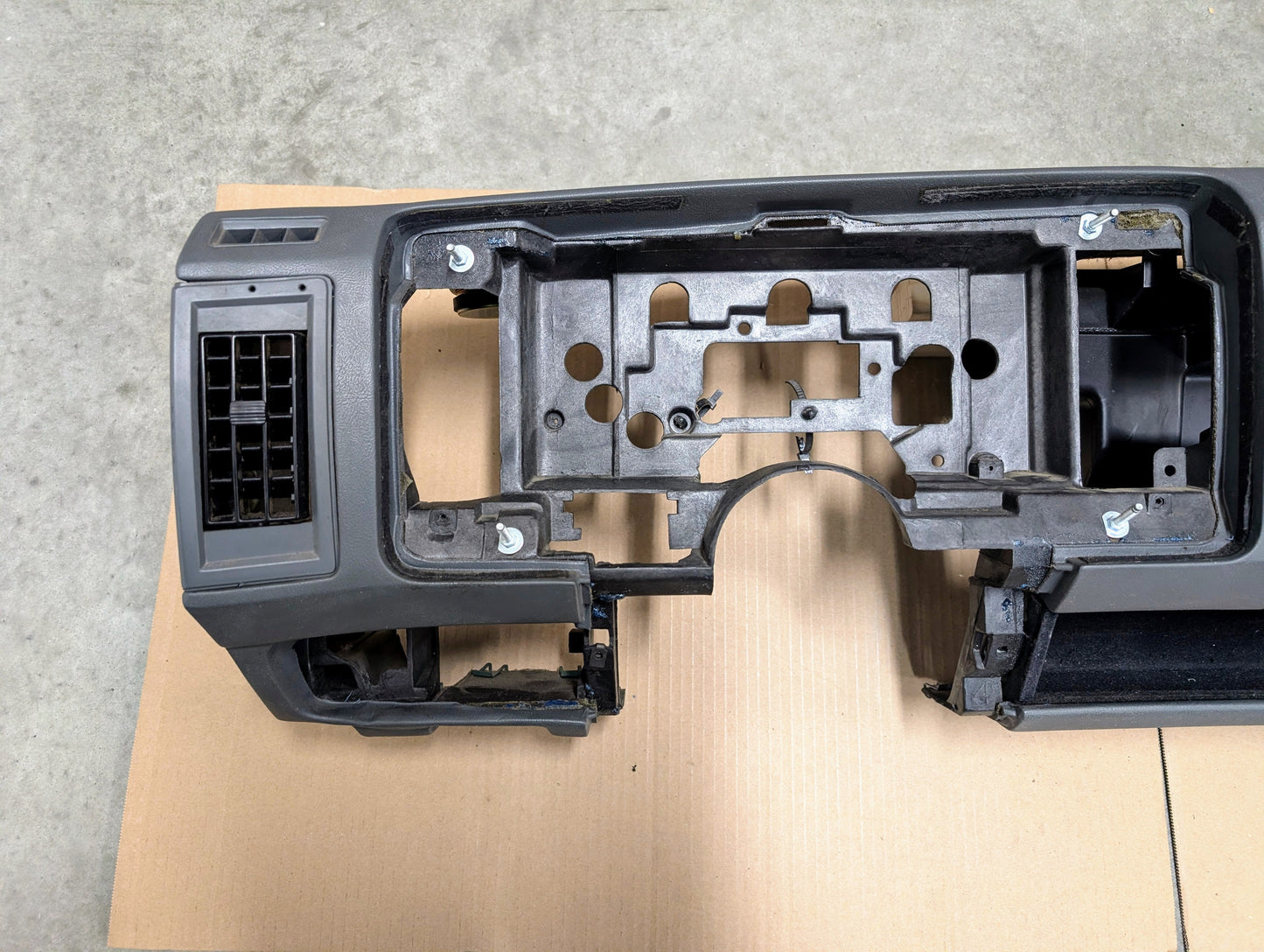 Closeup of Black/Dark Gray Dashboard with a gray background