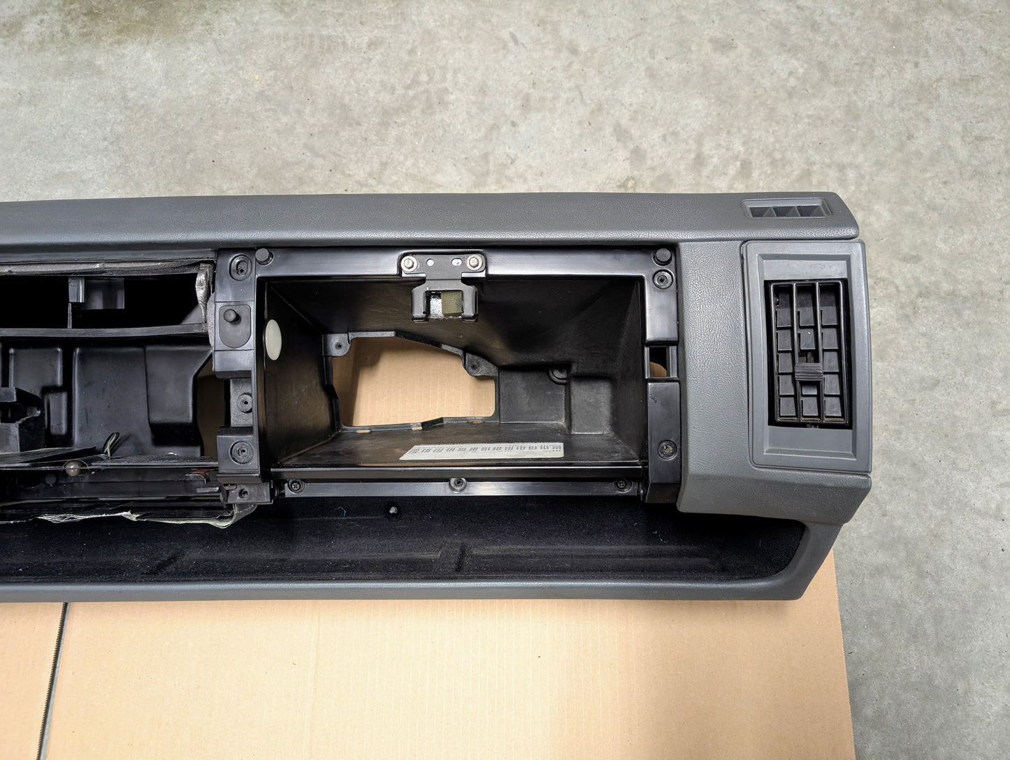 Close-up of a Dark Gray/Black Dashboard on a gray surface
